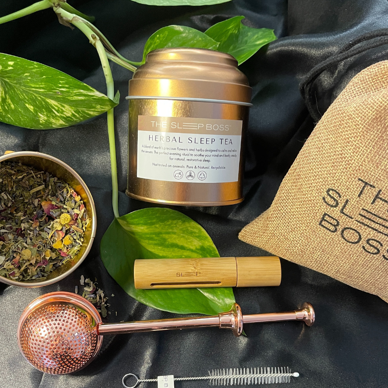 flat lay picture of Calm Ritual Kit includes Herbal Sleep Tea and Sleep Roller with free gold tea infuser and roller brush cleaner