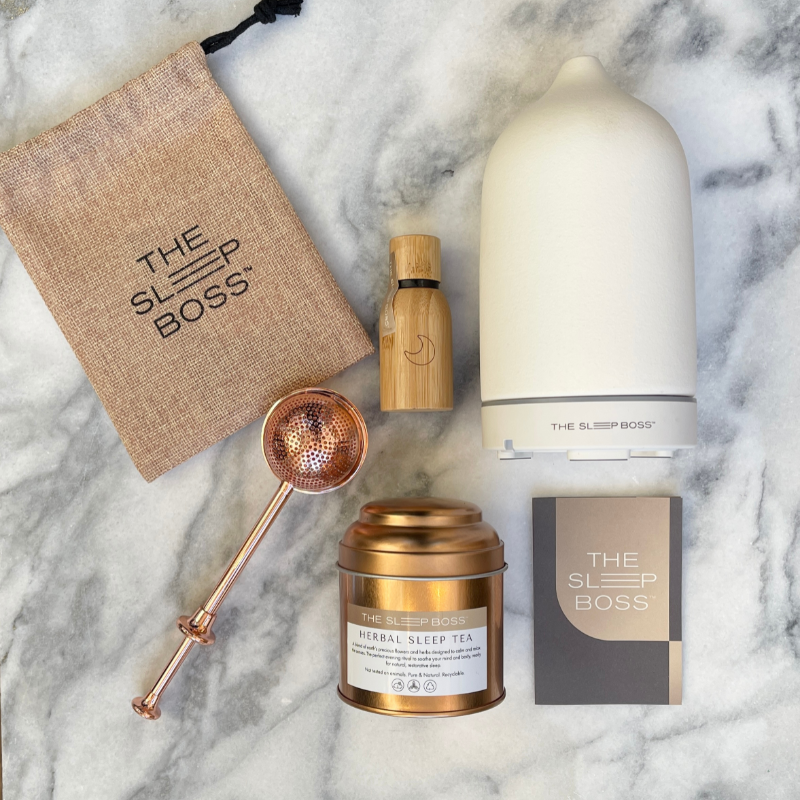 Tranquility gift set with herbal sleep tea, sleep essential oil blend and white diffuser on a marble base