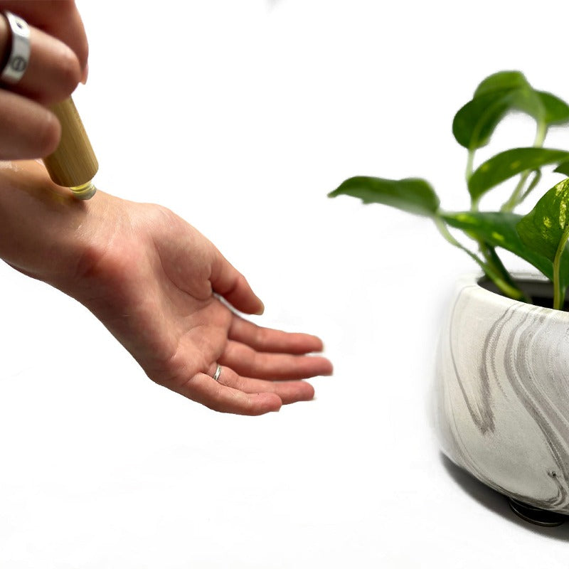 Essential oil roller being applied on common pulse point, the wrist