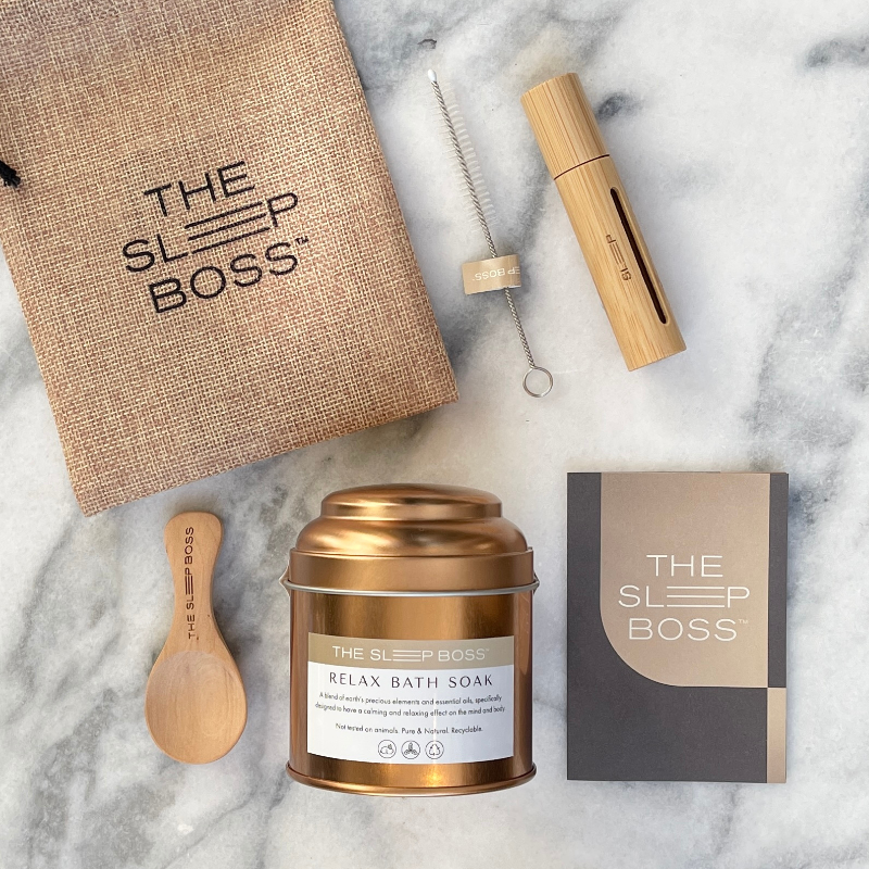 Relaxing Bath Soak and sleep essential oil roller in a kit on a marble table