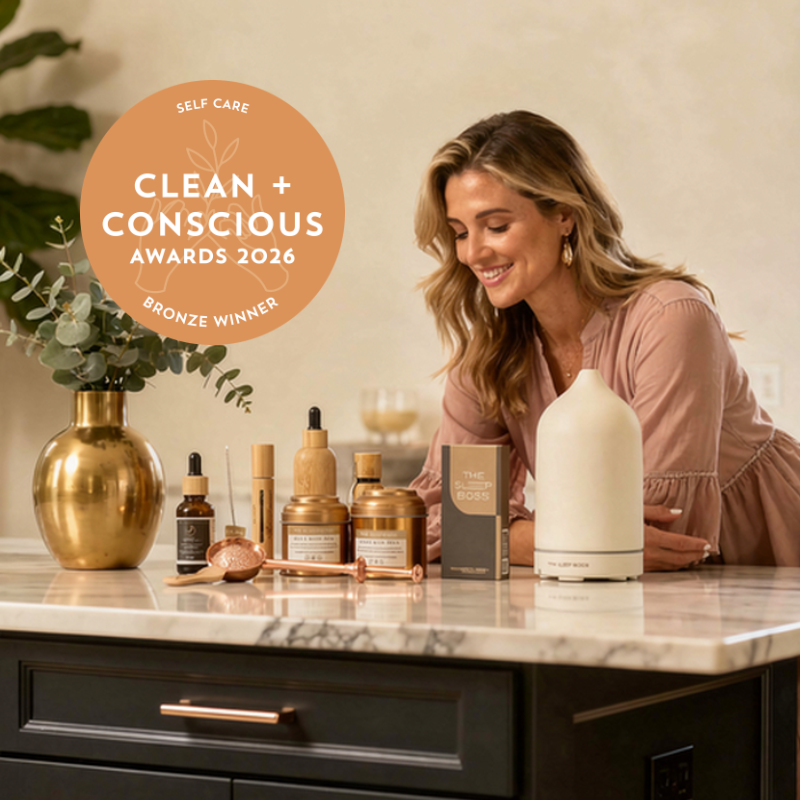 a woman looking at the award winning glow self care luxe set on a marble table