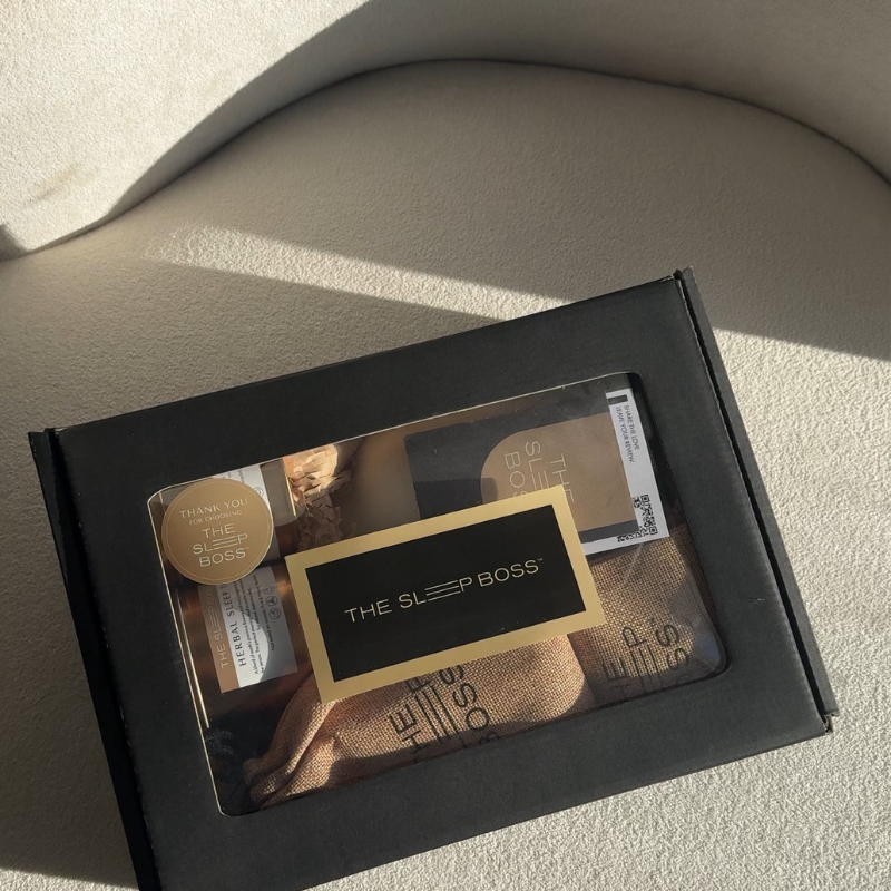 Product packaging for 'The Sleep Boss' on a light beige surface