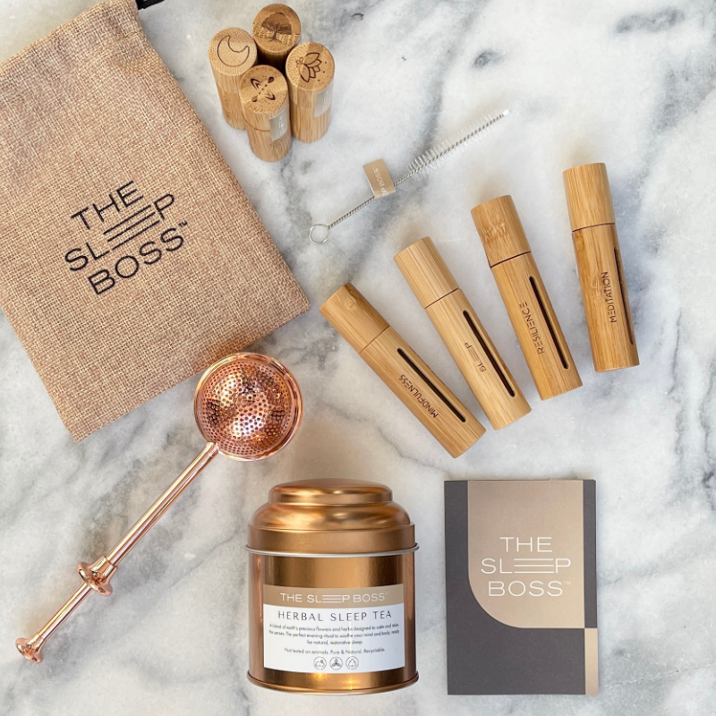 Peaceful Pack with herbal tea and essential oil roller set on marble table