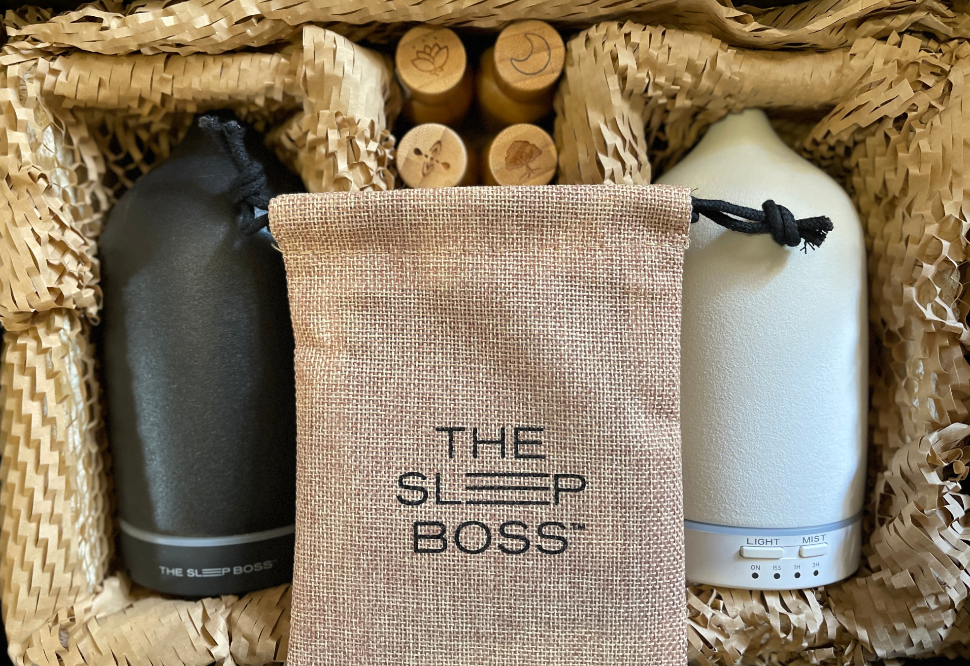 a black and a white ceramic diffusers, oil blends in bamboo casing and a pouch inside a gift box